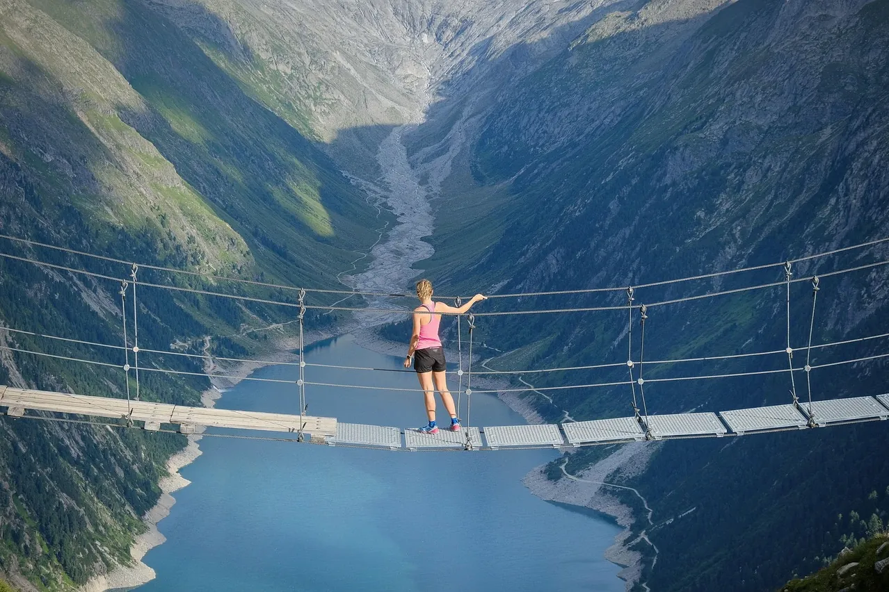 Lake, mountains, suspension bridge